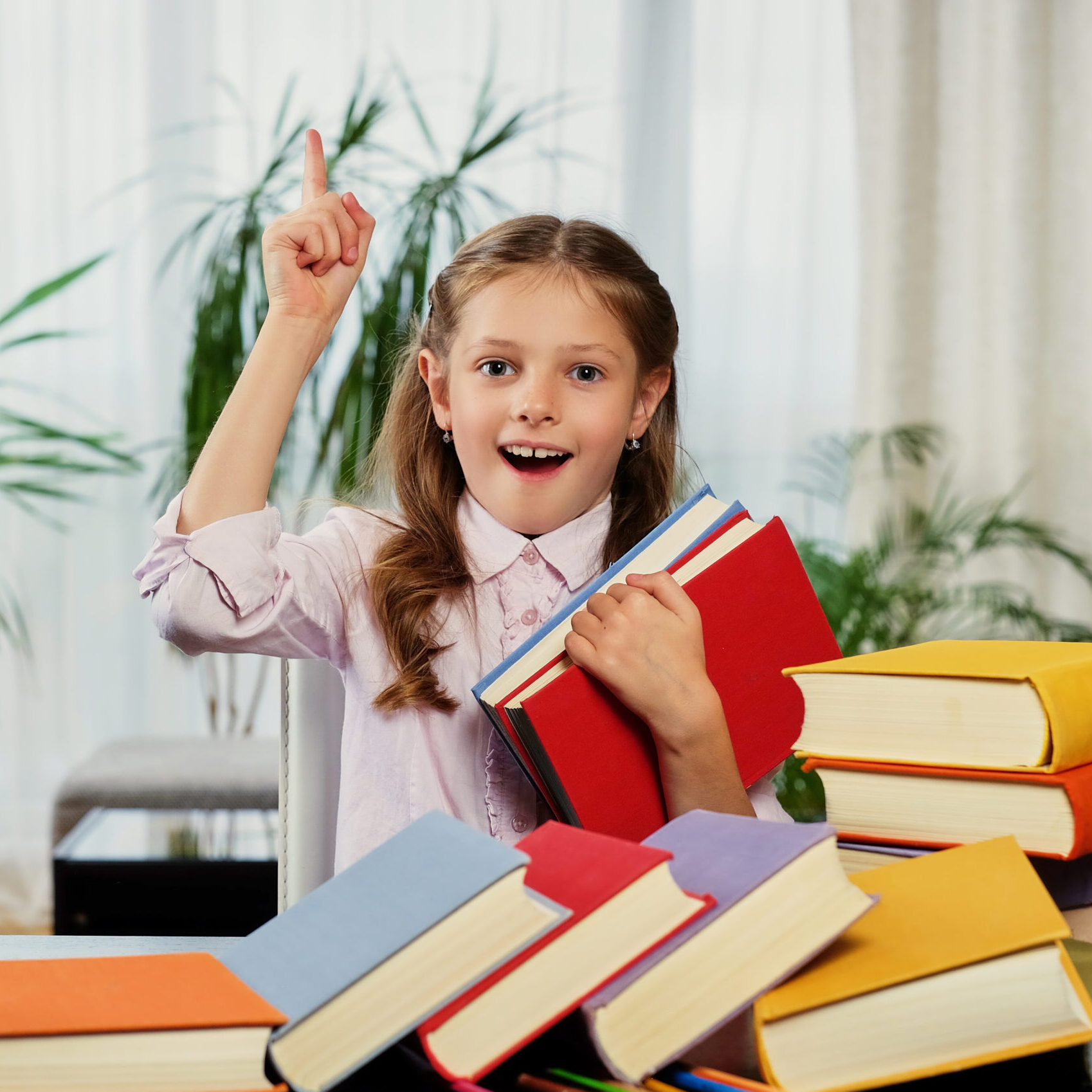 Positive little girl likes reading.